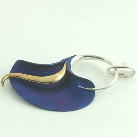 Open calla lily silver pendant. Calla lily jewelry in blue titanium and gold
