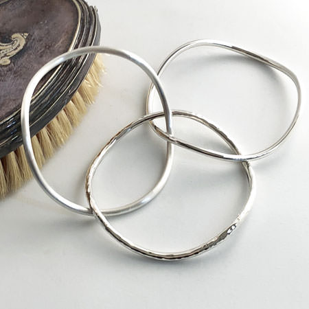 three curved silver stack bracelet