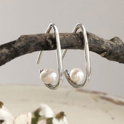 Small cradled pearl earrings